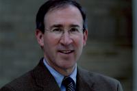 Headshot of Dr. Lamster who is black haired white man. He is smiling at the camera .